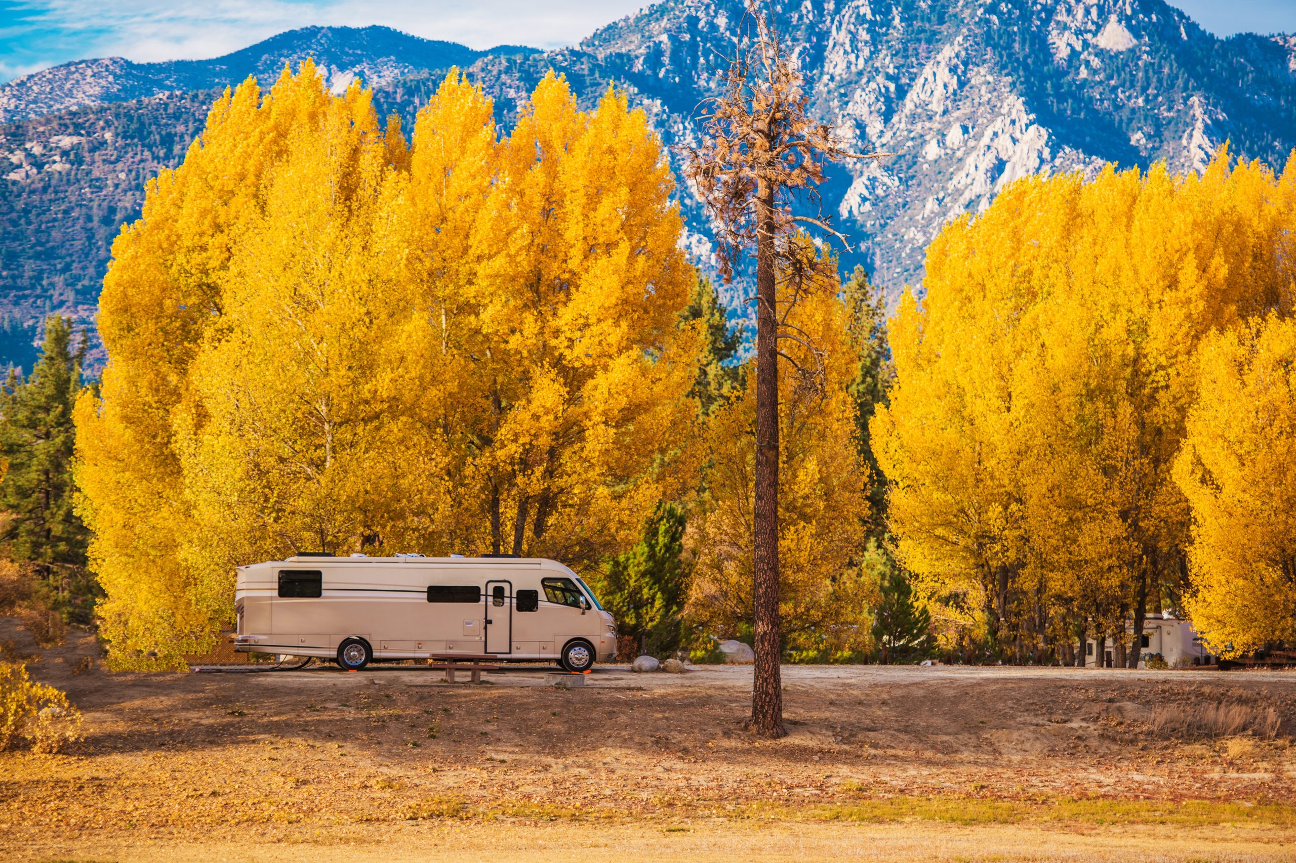 Motorhome RV in the California Mountains. Class A Diesel Motorhome and the Scenic Fall Foliage. Camping in Style.
